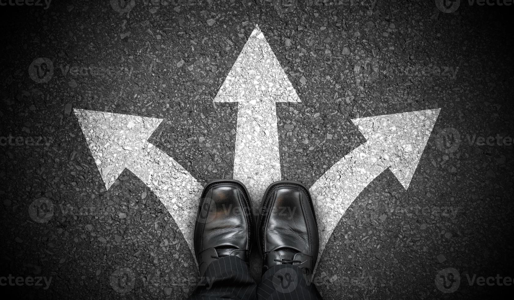 Black Business Shoes and Three Chalky Arrows on Asphalt - Decision Concept photo