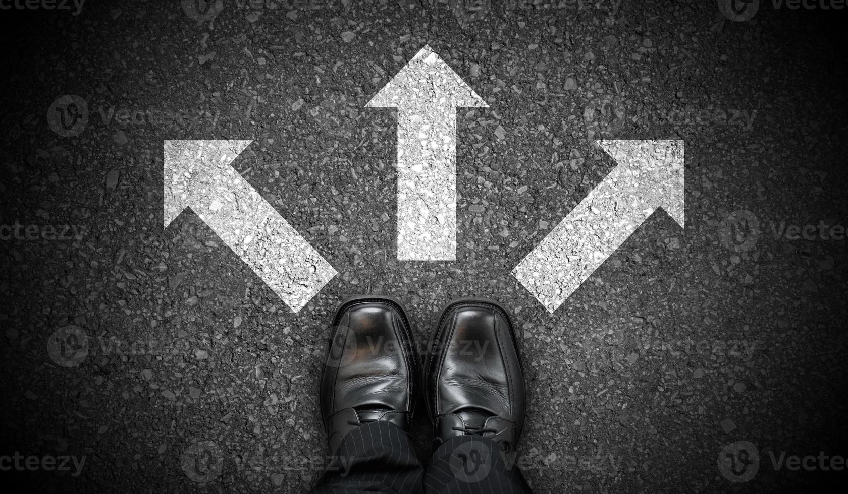 Black Business Shoes and Three Chalky Arrows on Asphalt - Decision Concept photo