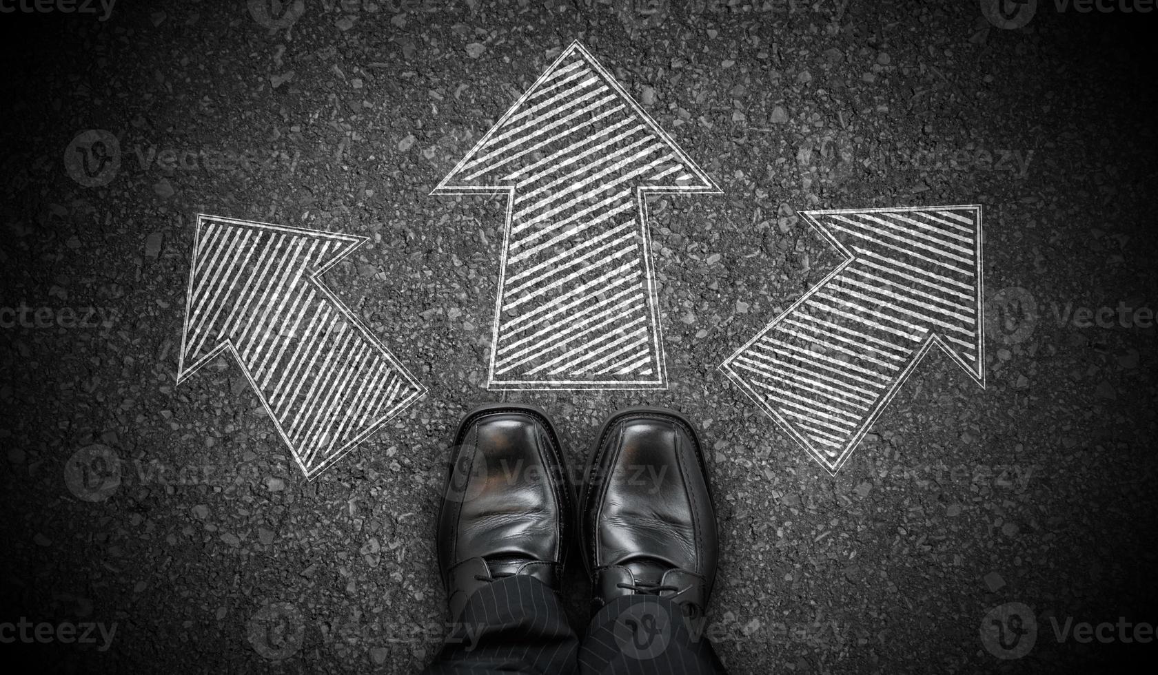 Black Business Shoes and Three Geometrical Chalky Arrows on Asphalt - Choice Concept photo