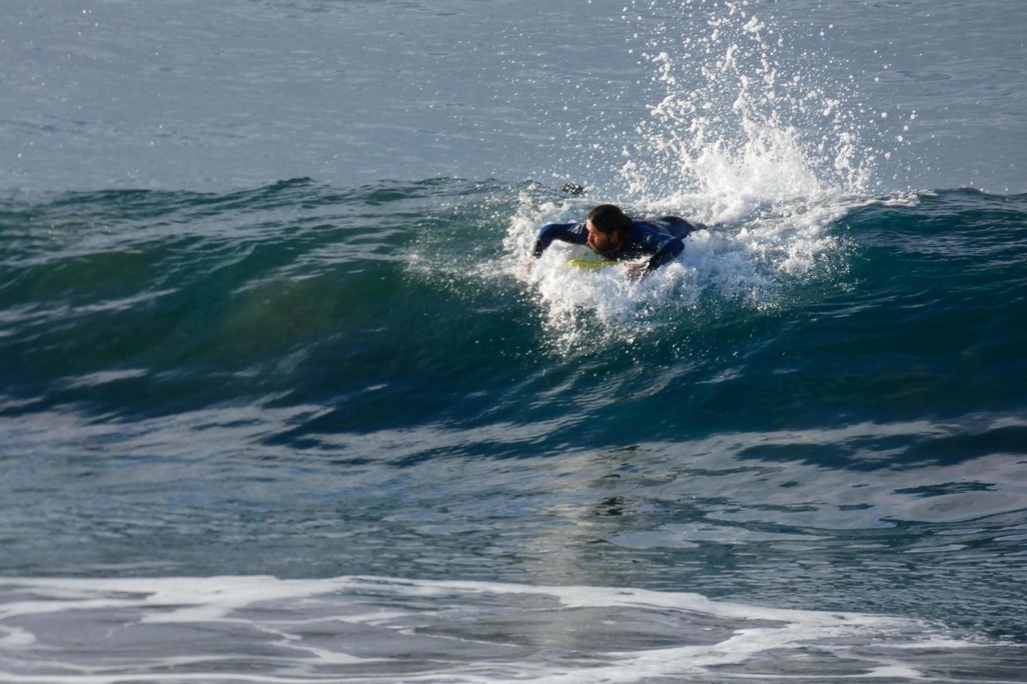 Surfers riding small ocean waves photo