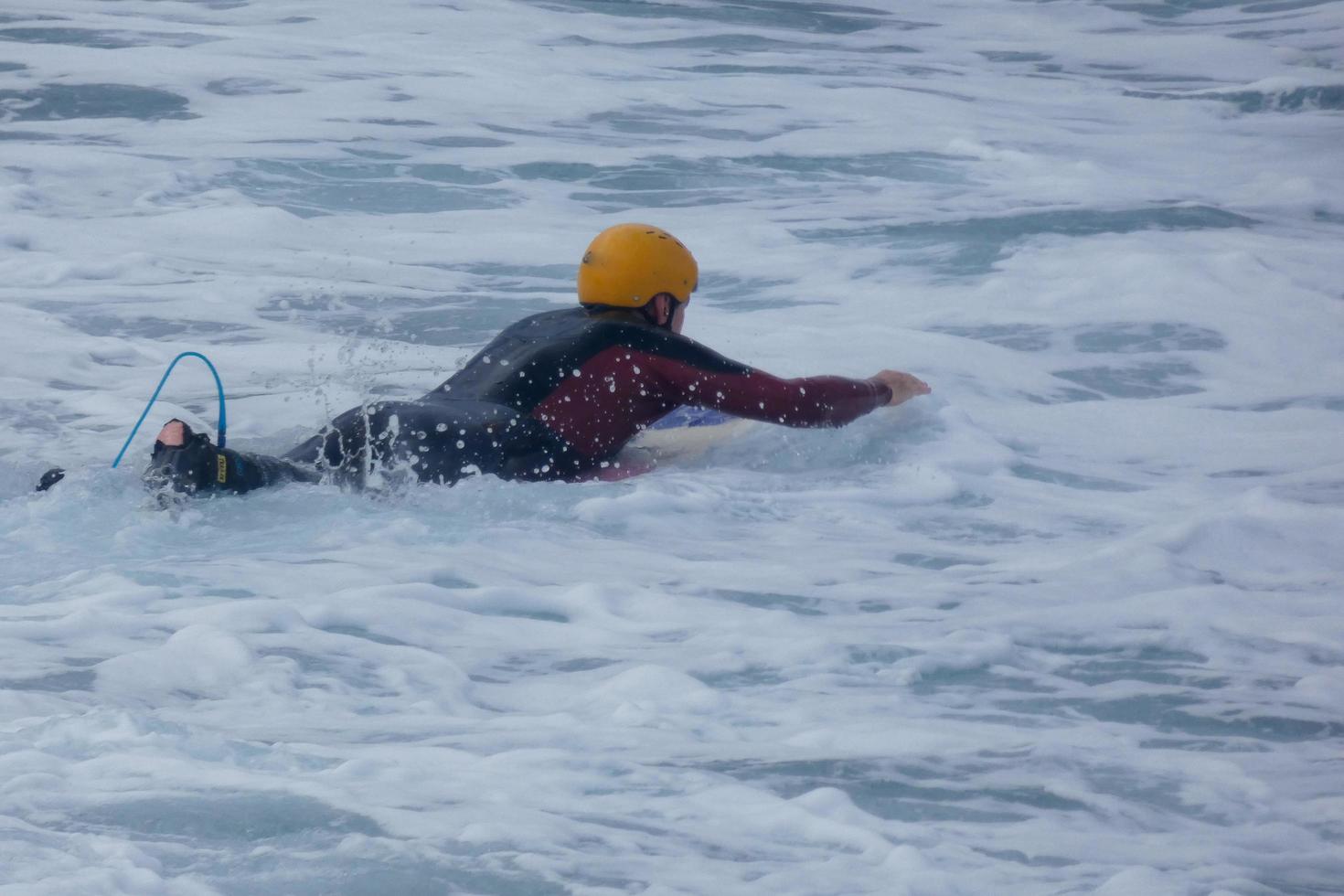 Surfers riding small ocean waves photo