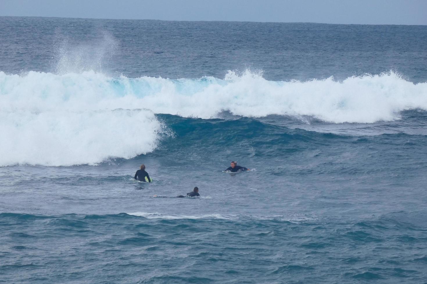 young athletes practising the water sport of surfing photo