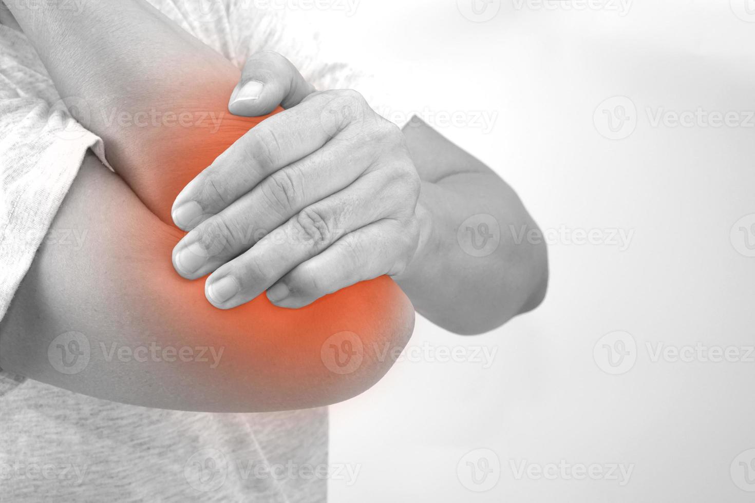 Woman suffering from elbow pain on white background. Healthcare and office syndrome concept. photo