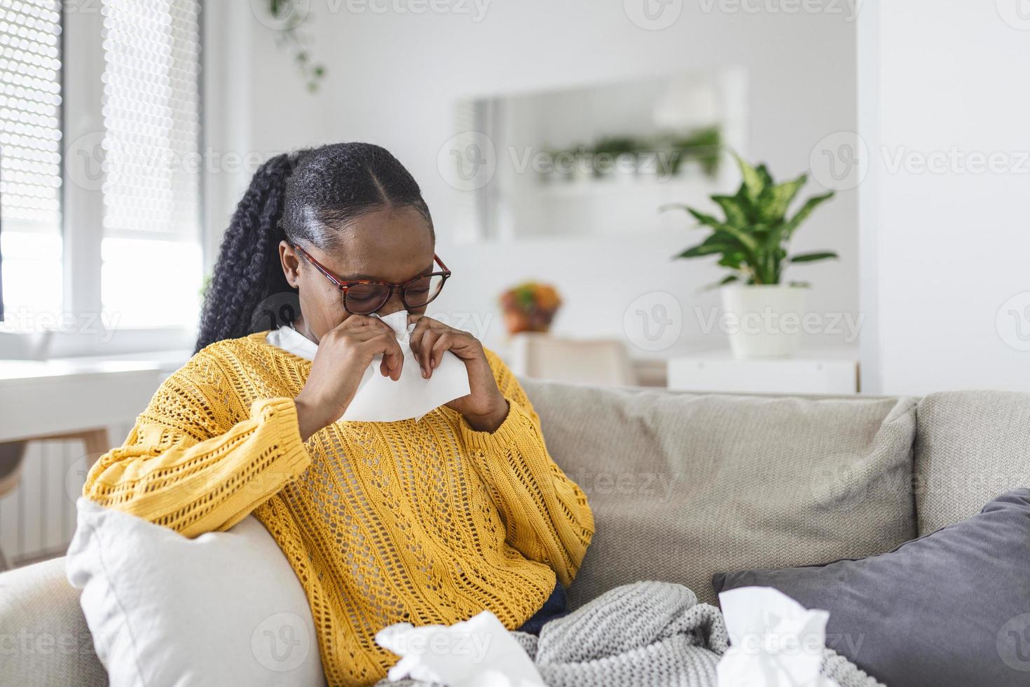 Sick day at home. Young woman has runny and common cold. Cough. Closeup Of Beautiful Young Woman Caught Cold Or Flu Illness. Portrait Of Unhealthy woman with coronavirus, covid19 symptoms photo