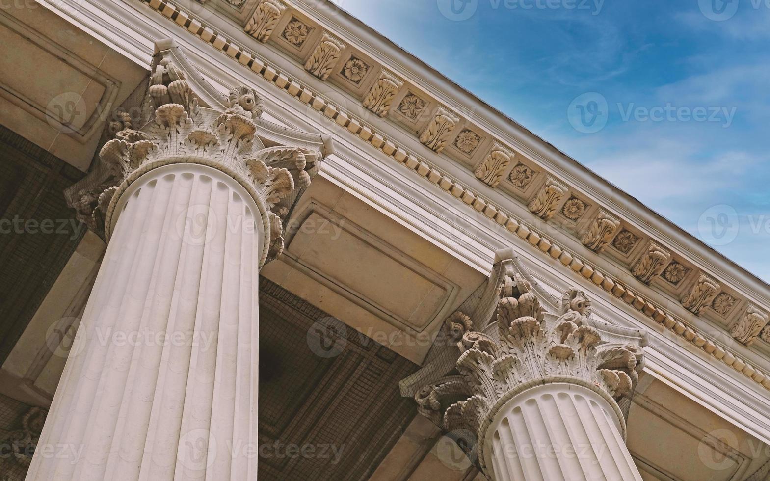 Classic architectural column. Details of architecture of historical construction. Element of exterior building with columns and Stucco molding on ceiling of architectural structure in London, UK. photo