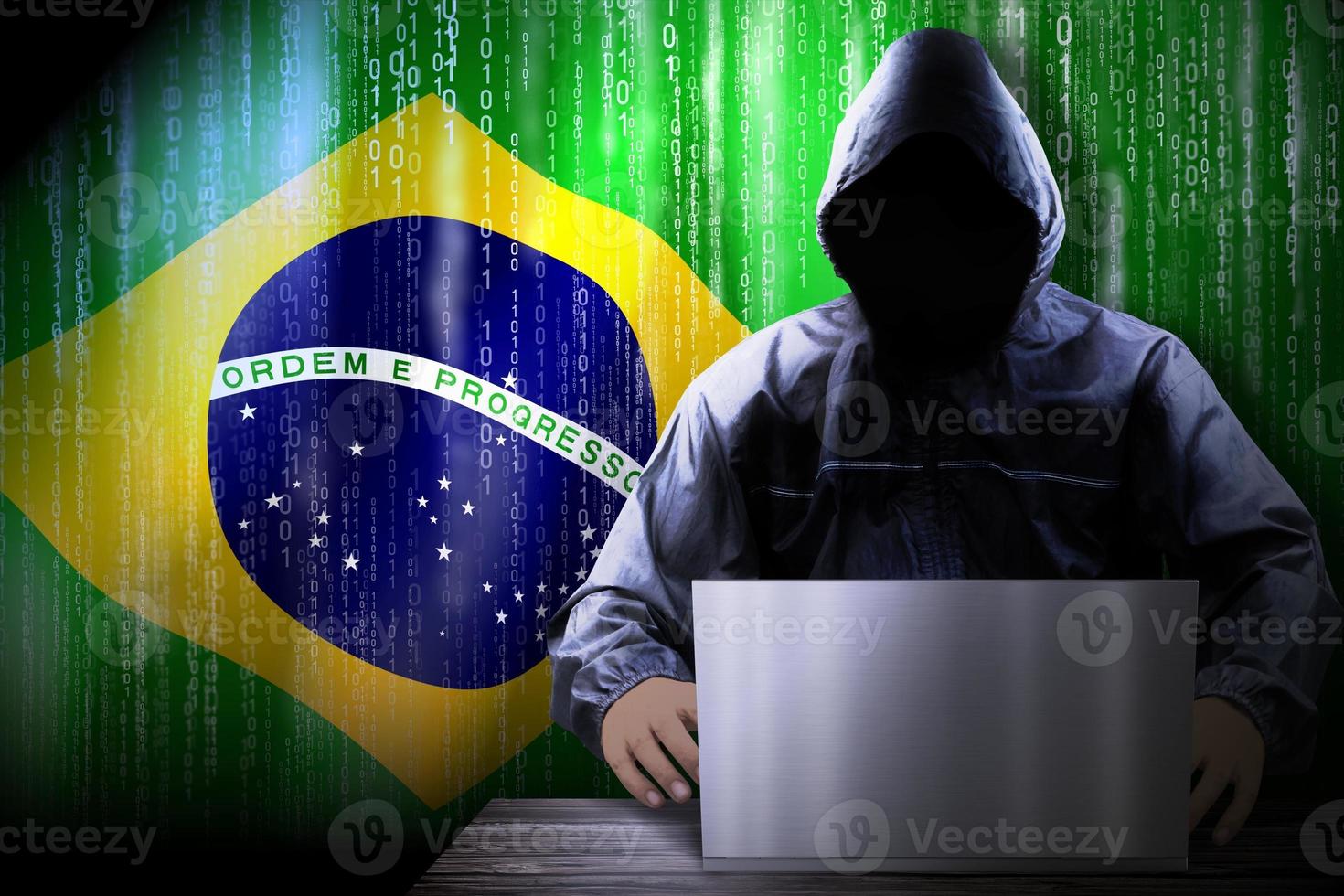 Anonymous Hooded Hacker and Flag Of Brazil, Binary Code - Cyber Attack Concept photo