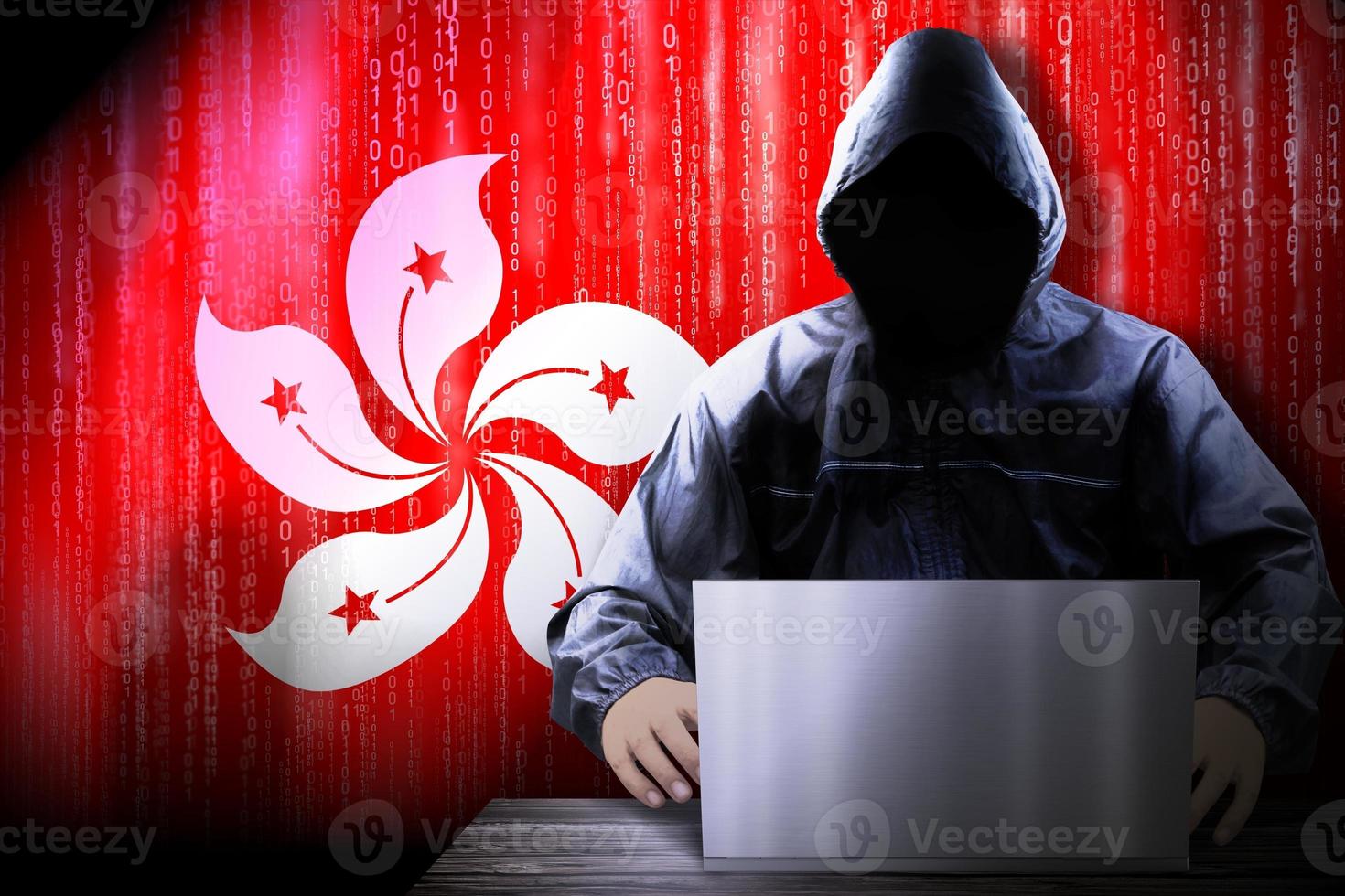 Anonymous Hooded Hacker and Flag Of Hong Kong, Binary Code - Cyber Attack Concept photo