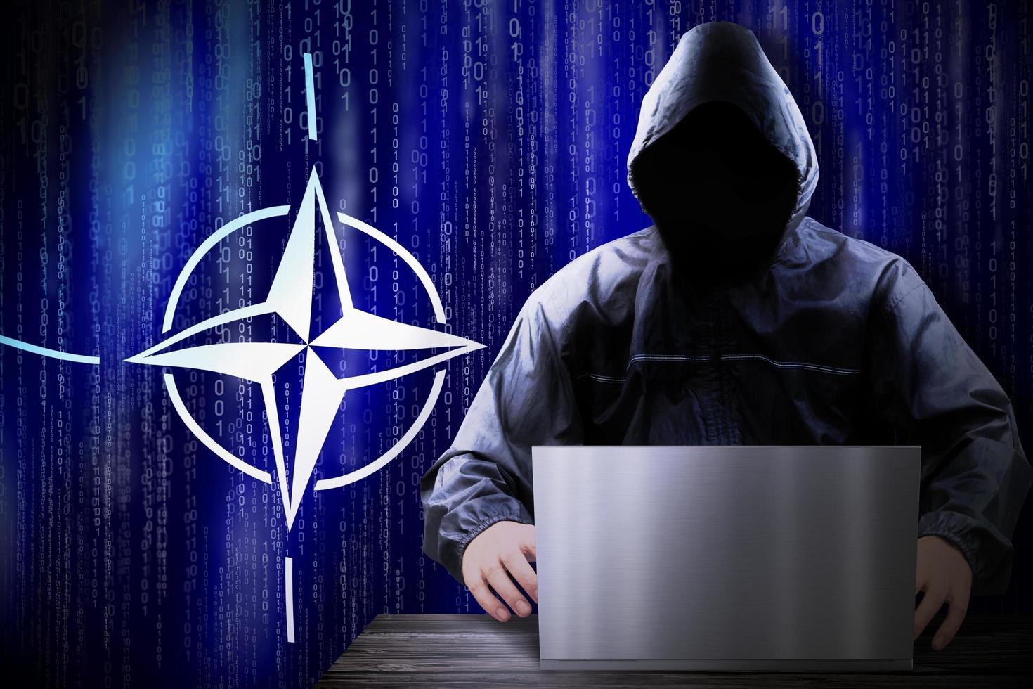 Anonymous Hooded Hacker and Flag Of Nato, Binary Code - Cyber Attack Concept photo