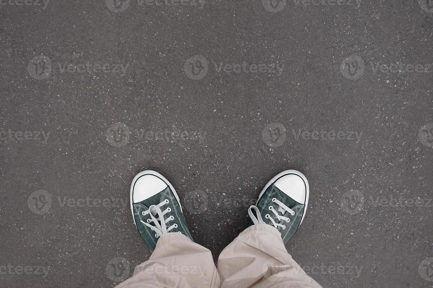 Legs with trainer shoes standing on asphalt - legs with trainer shoes photo