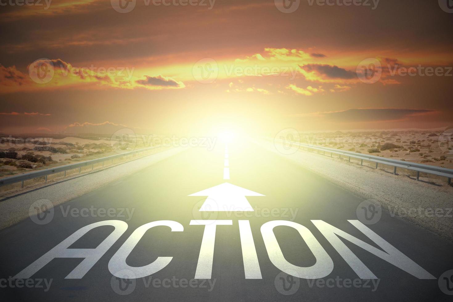 Action word on a road and sunset sky photo