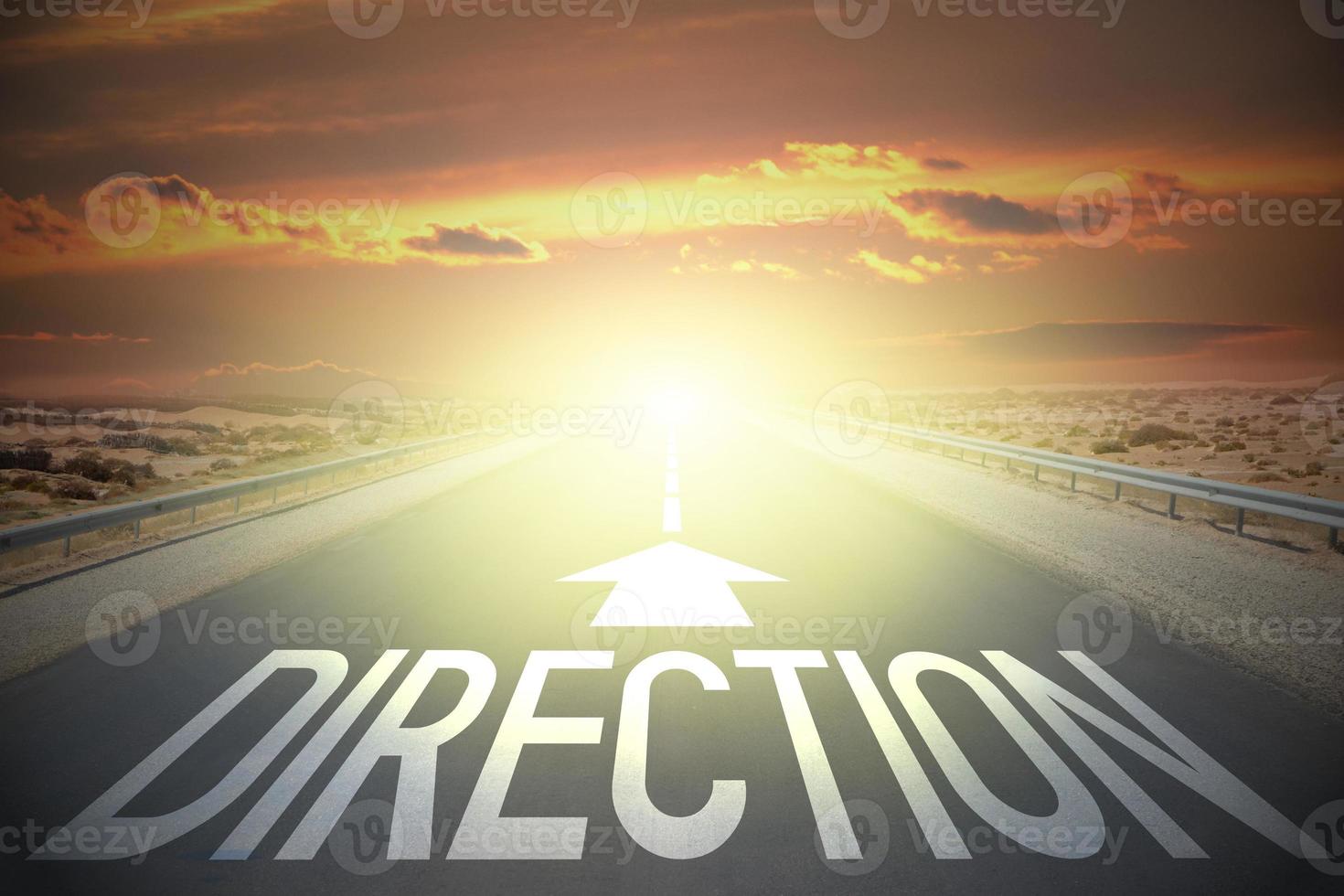 Direction word and arrow on a road and sunset sky - confusion concept photo