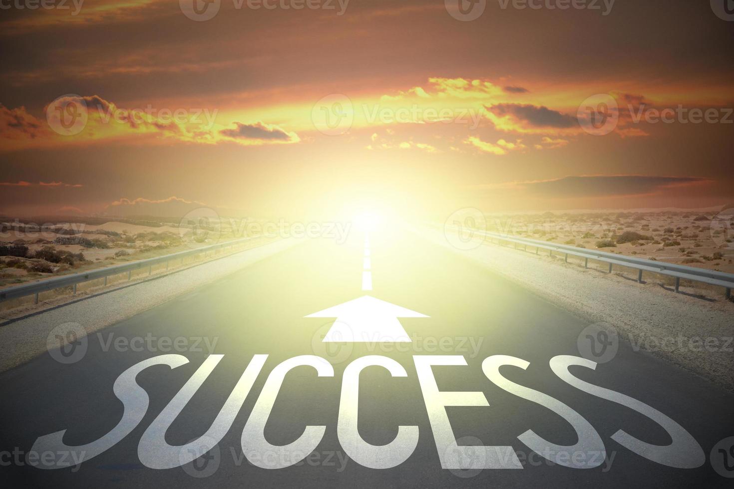 Success word on a road and sunset sky photo