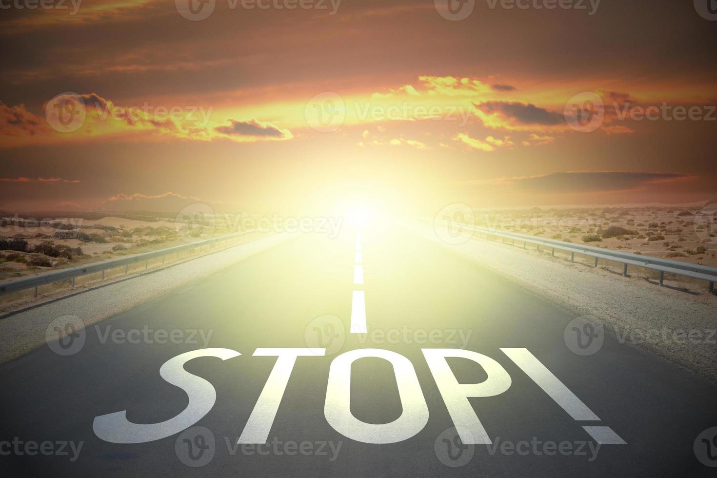 Stop word on a road and sunset sky photo