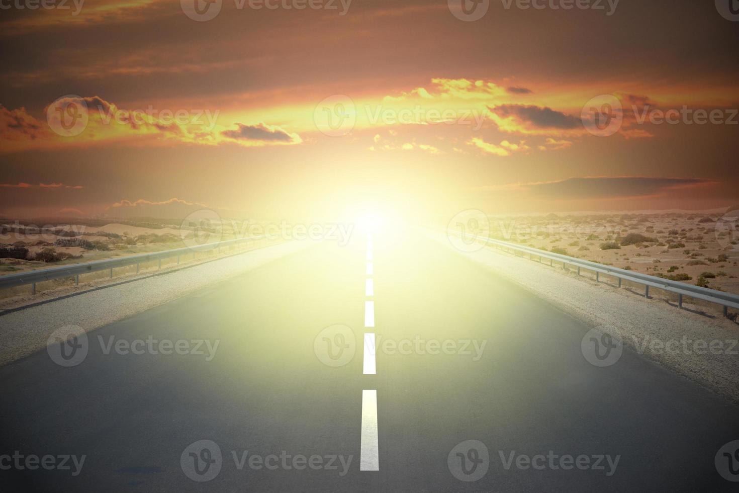 Empty road on a desert with sunset sky photo