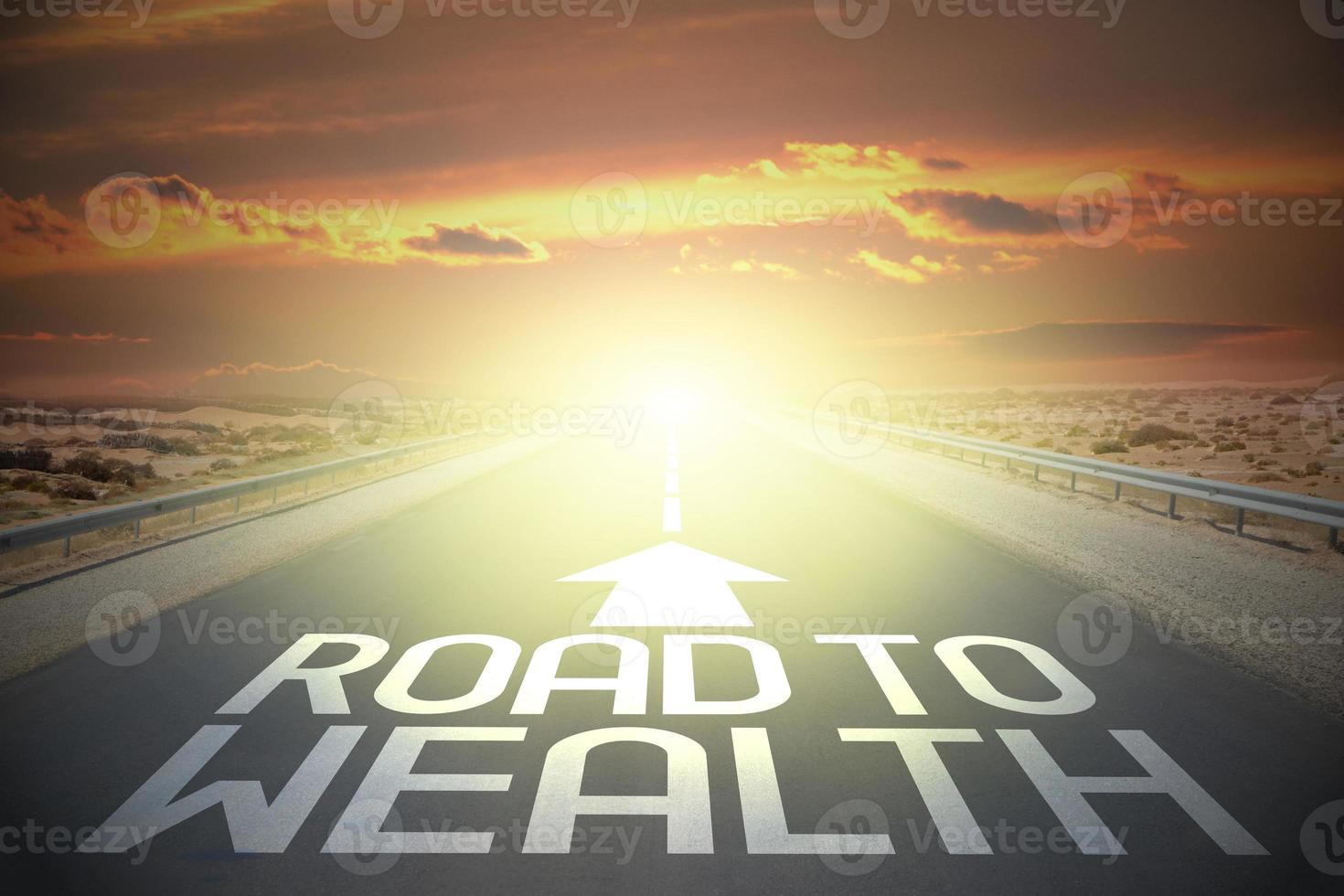 Road to wealth word on a road and sunset sky photo