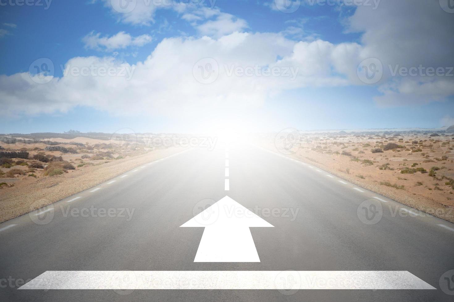 Road on A Desert with An Arrow and Sky with Clouds - Forward Concept photo