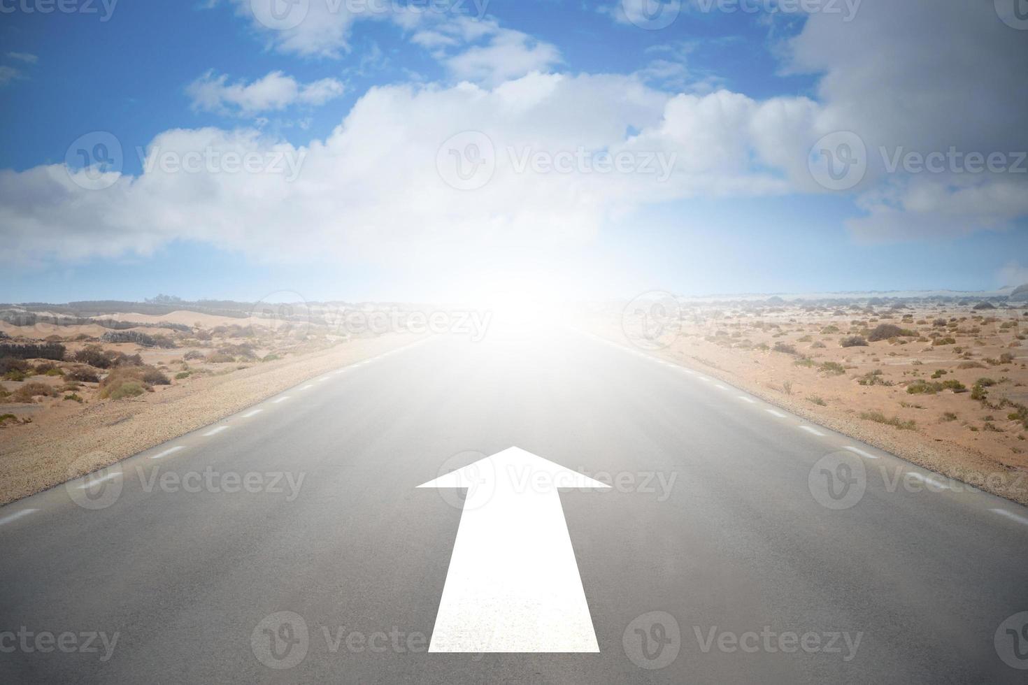 Road on A Desert with An Arrow and Sky with Clouds - Forward Concept photo