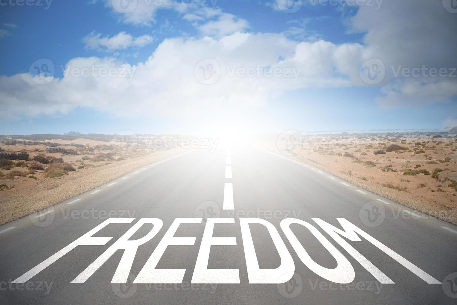 Freedom Word on A Road and Sky with Clouds photo