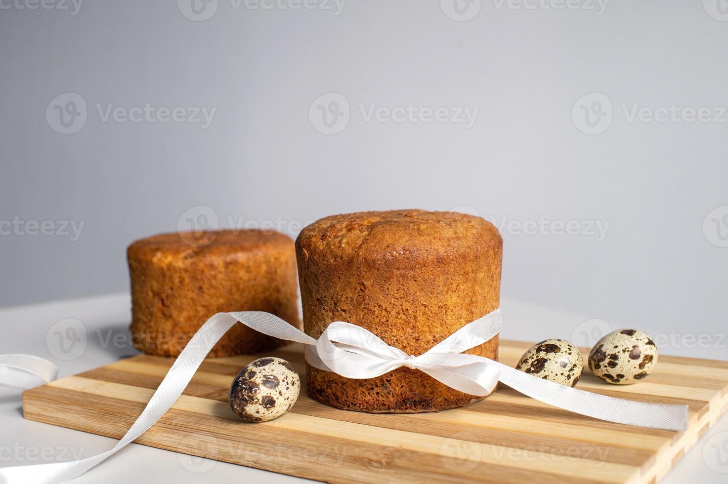 Easter pastries , sponge cake on a wooden board . Quail eggs. Place for text photo