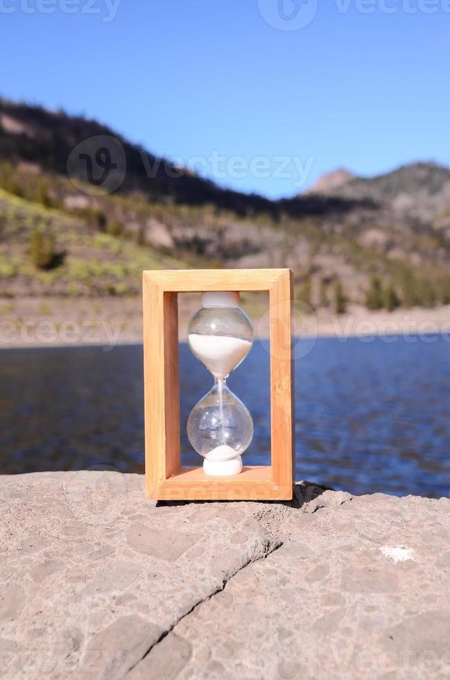 Hourglass on the rock photo