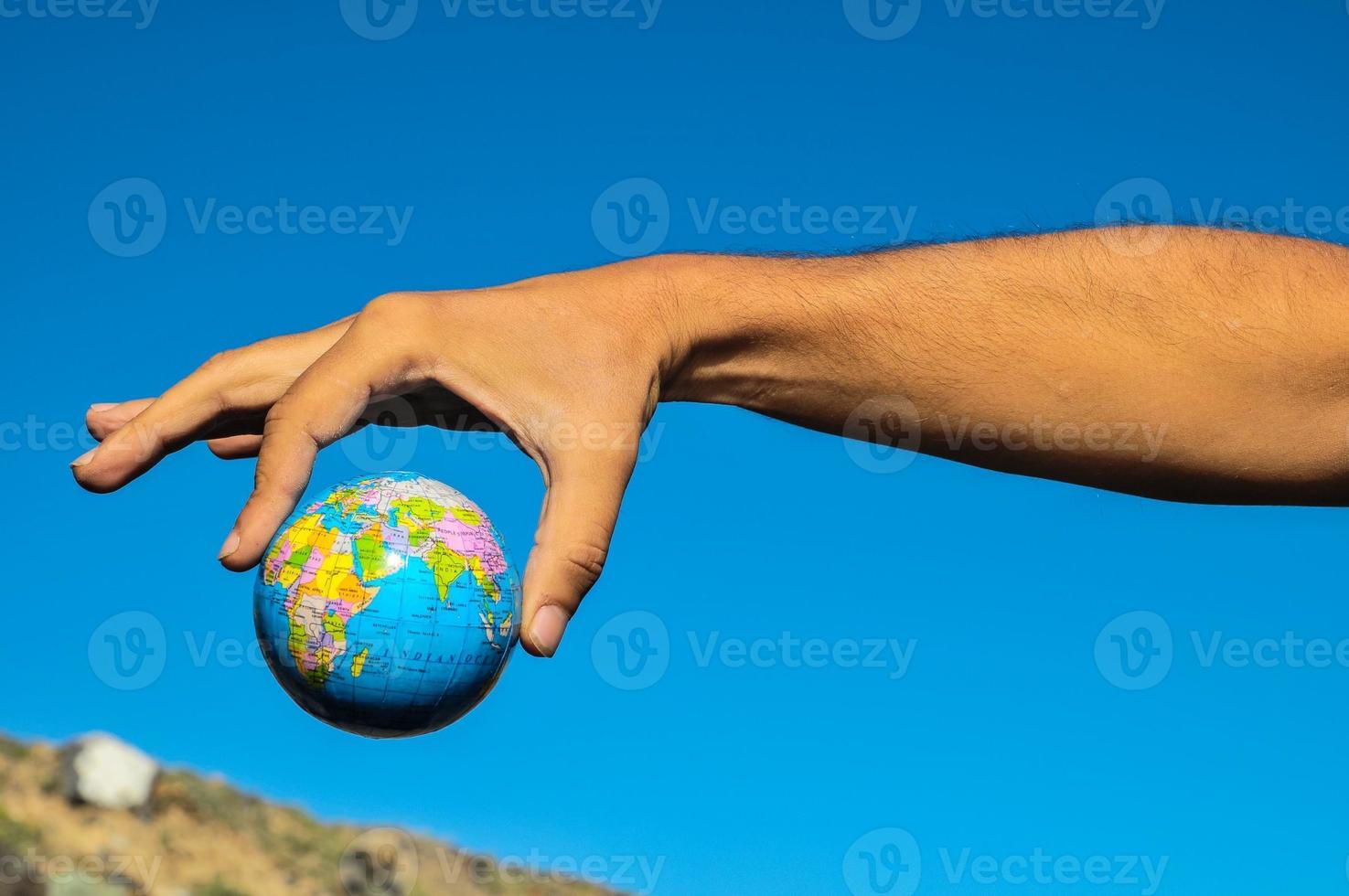 Hand holding a small globe photo