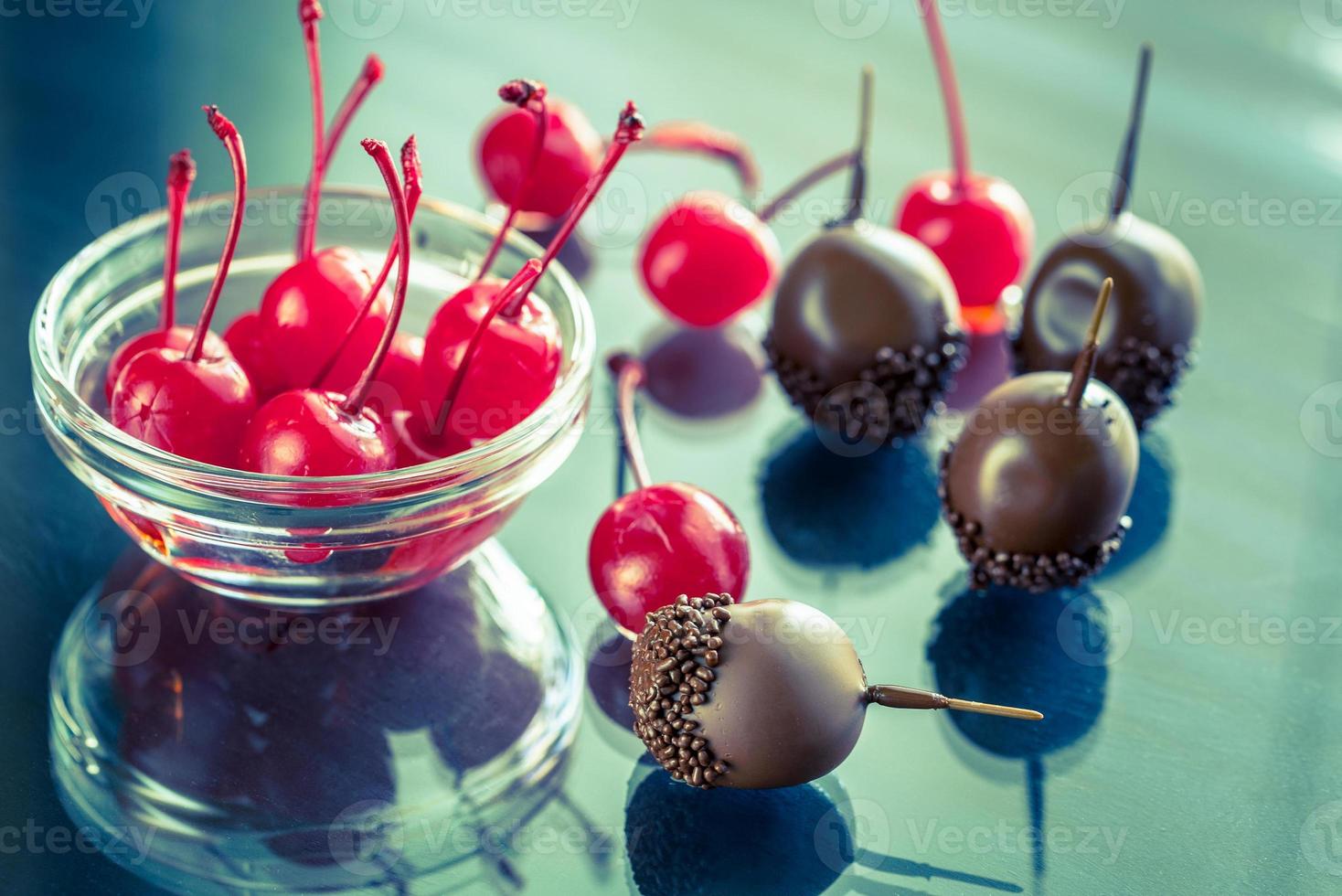 Chocolate and cocktail cherries on the glass photo