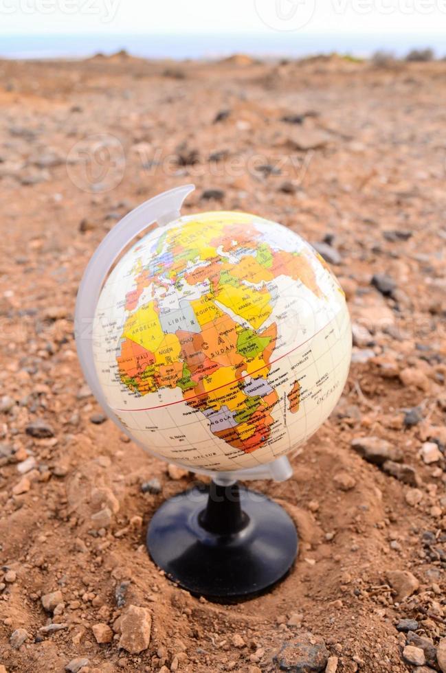 Globe in the sand photo