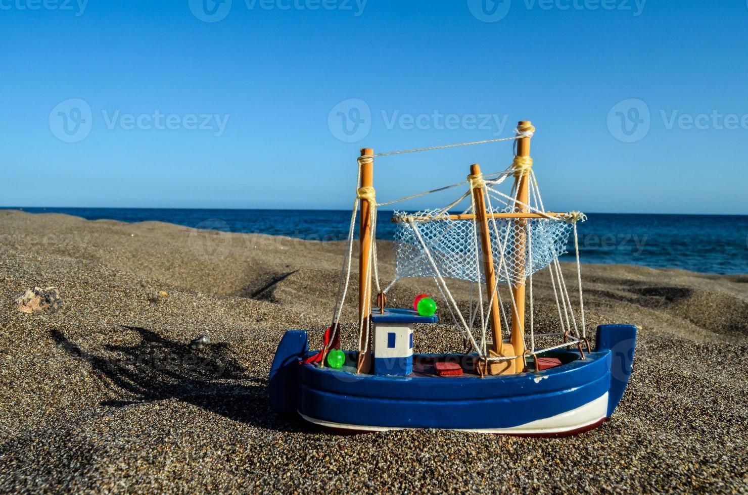 Toy ship in the sand photo