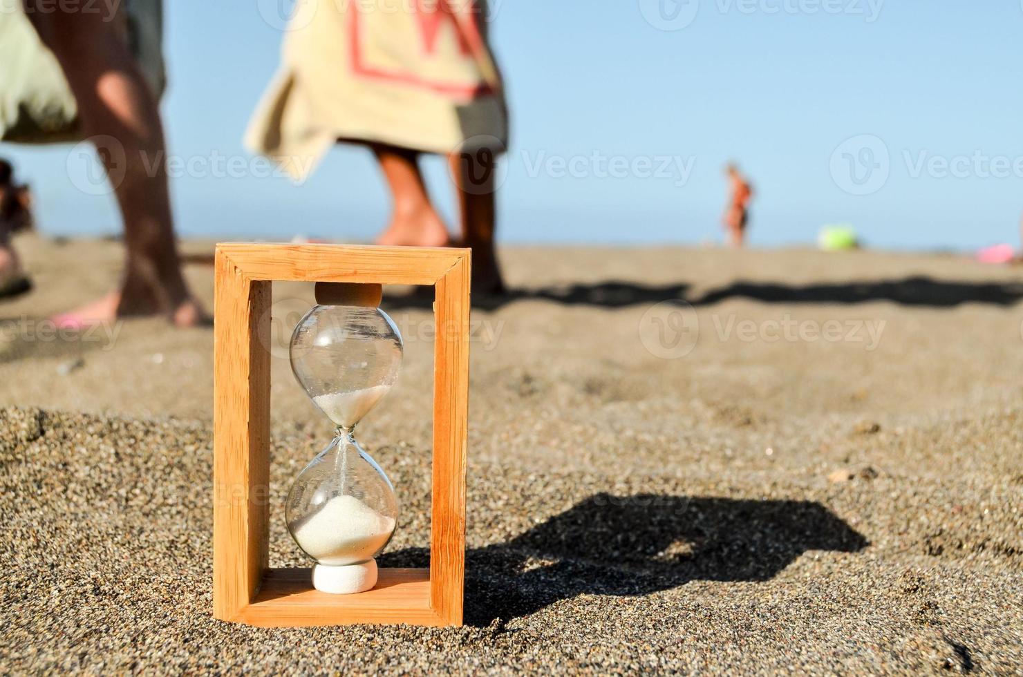 Hourglass in the sand photo