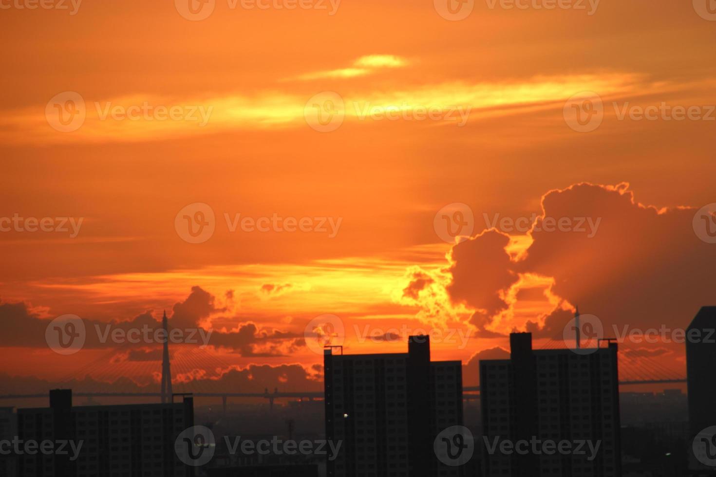 bright golden cloudy sky in sunset background in city building town photo