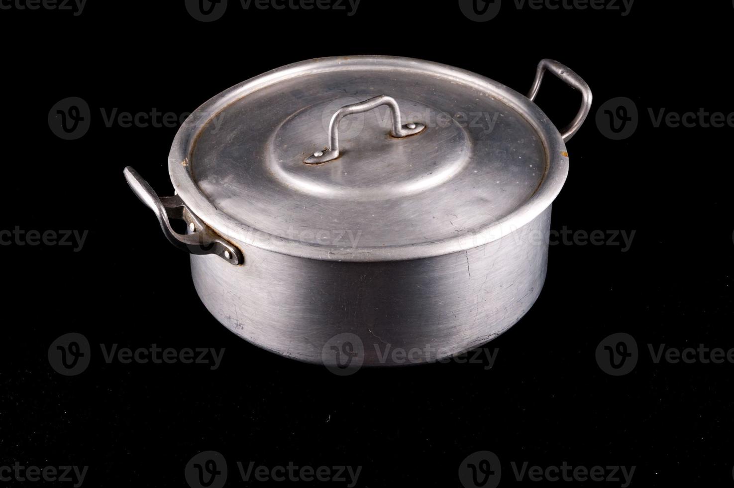 Metal pot on dark background photo