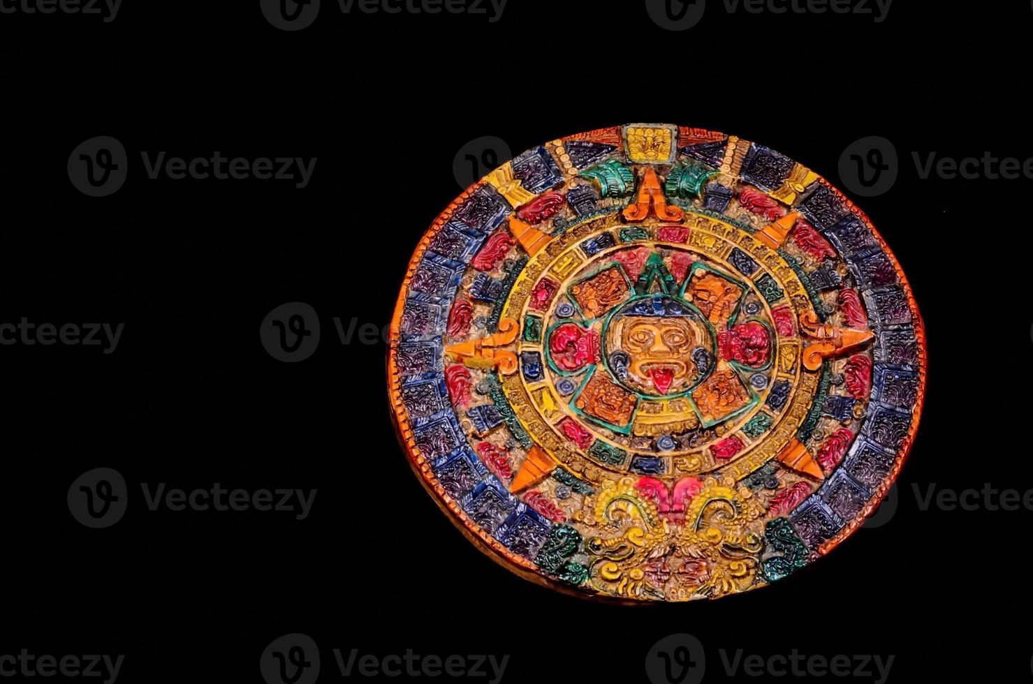 Mayan calendar on dark background photo