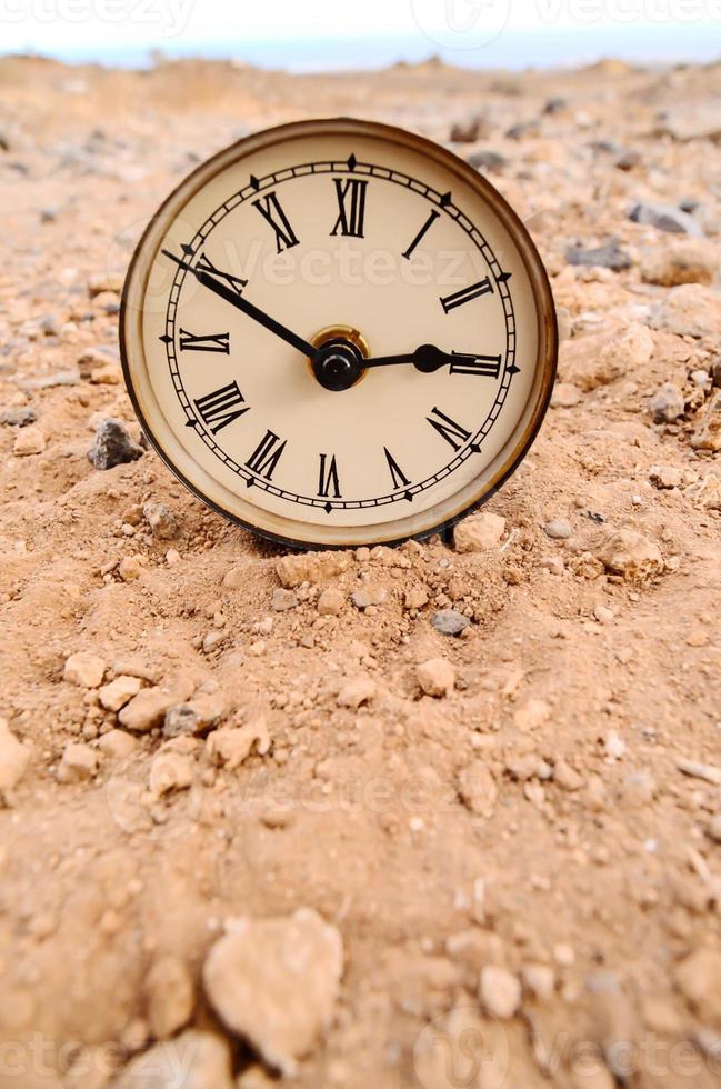 Clock in the sand photo