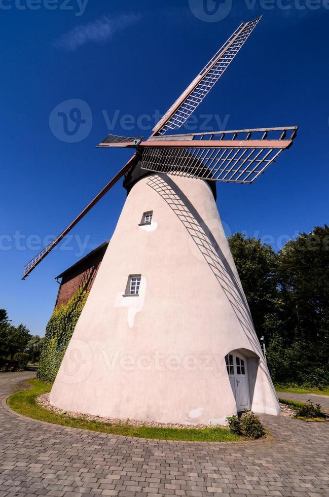 Old white windmill photo