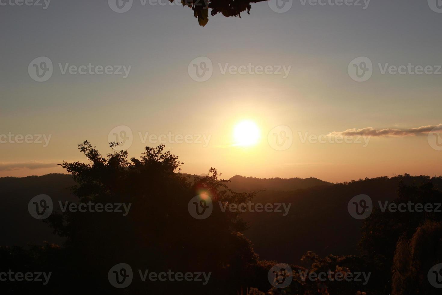 sunrise sunset sky with clouds over the mountain view background photo