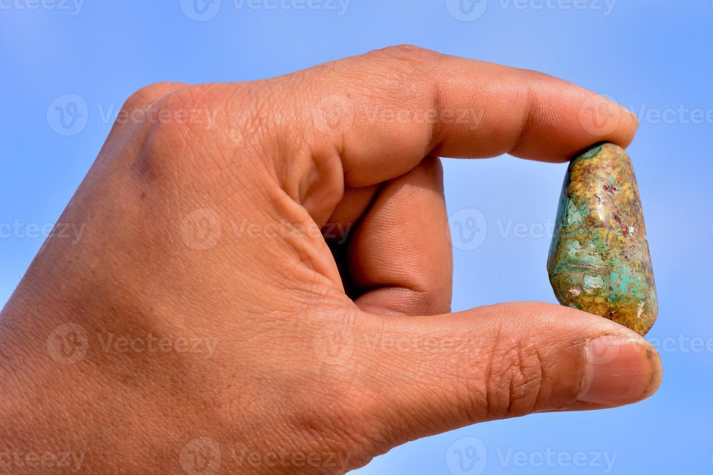 Hand holding a gemstone photo