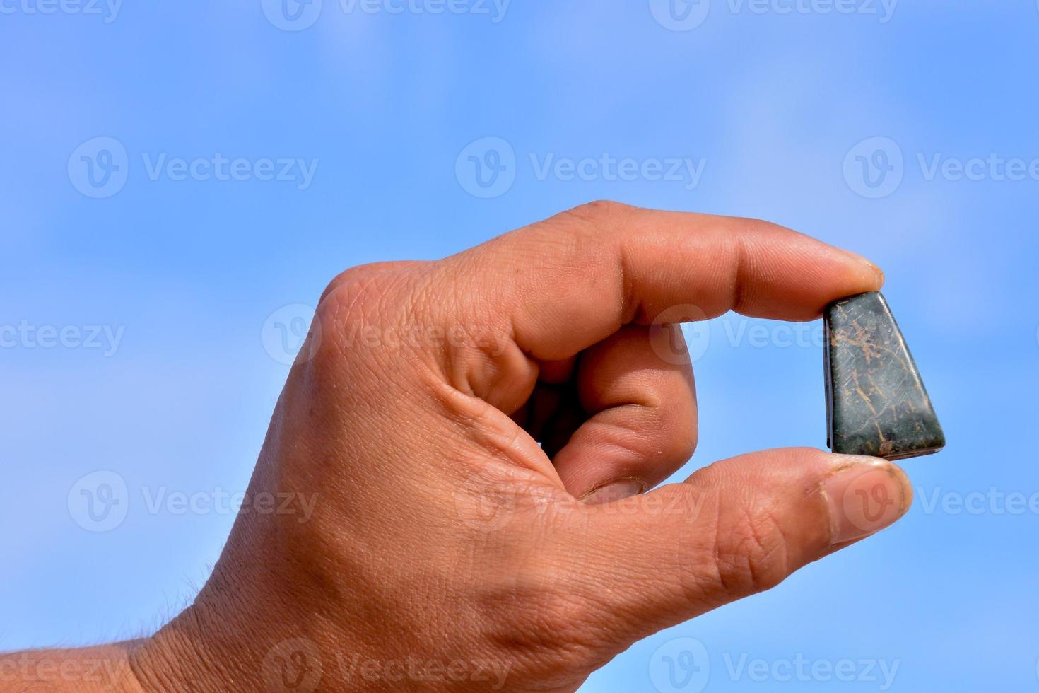 Hand holding a gemstone photo