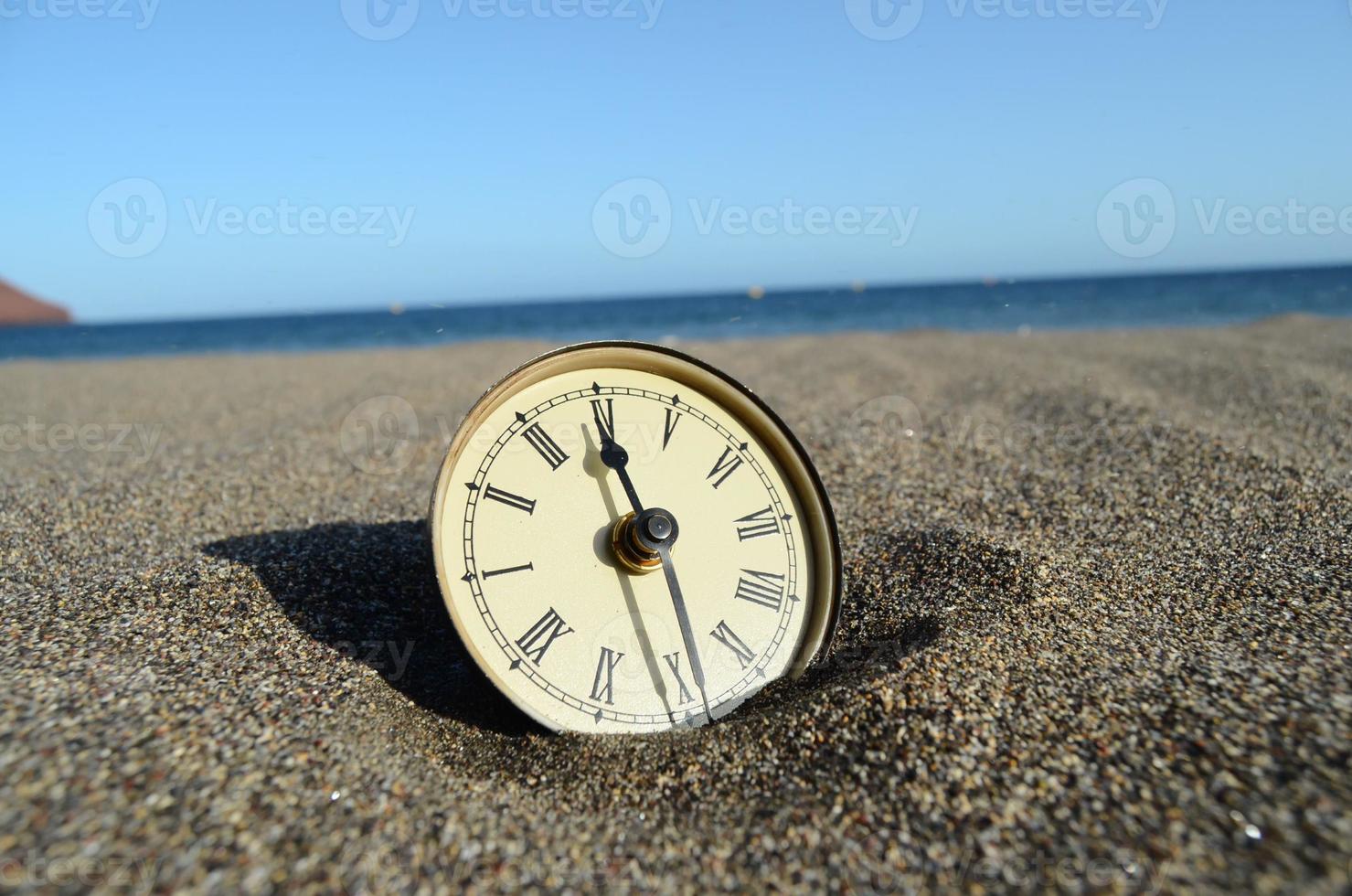 Clock in the sand photo