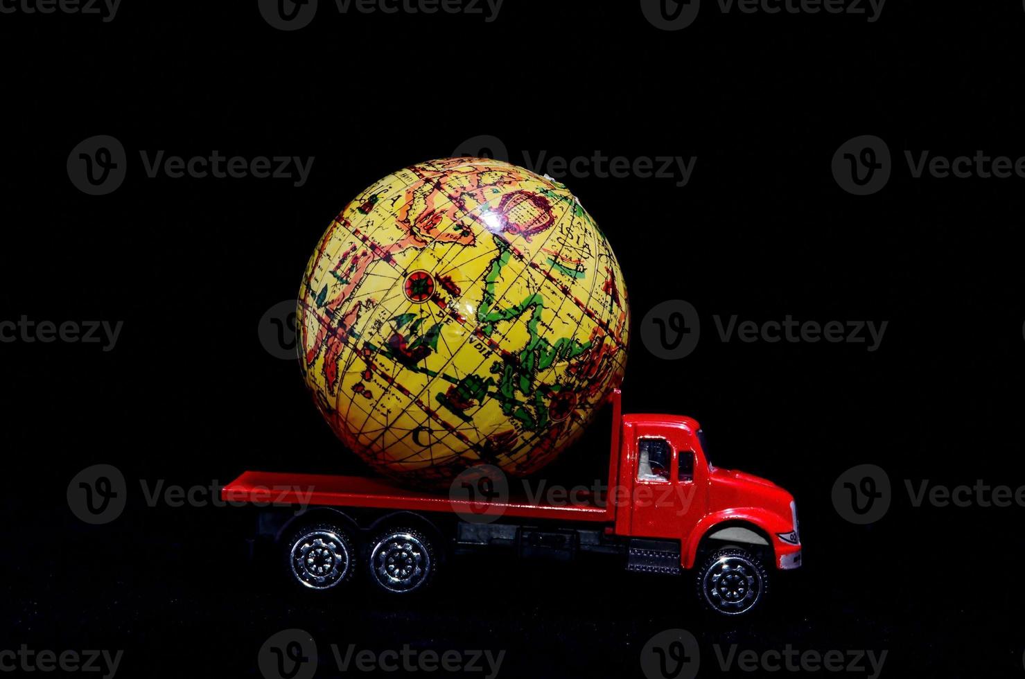 Red toy truck on dark background photo