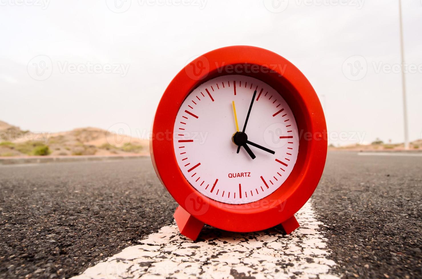 Clock on the road photo