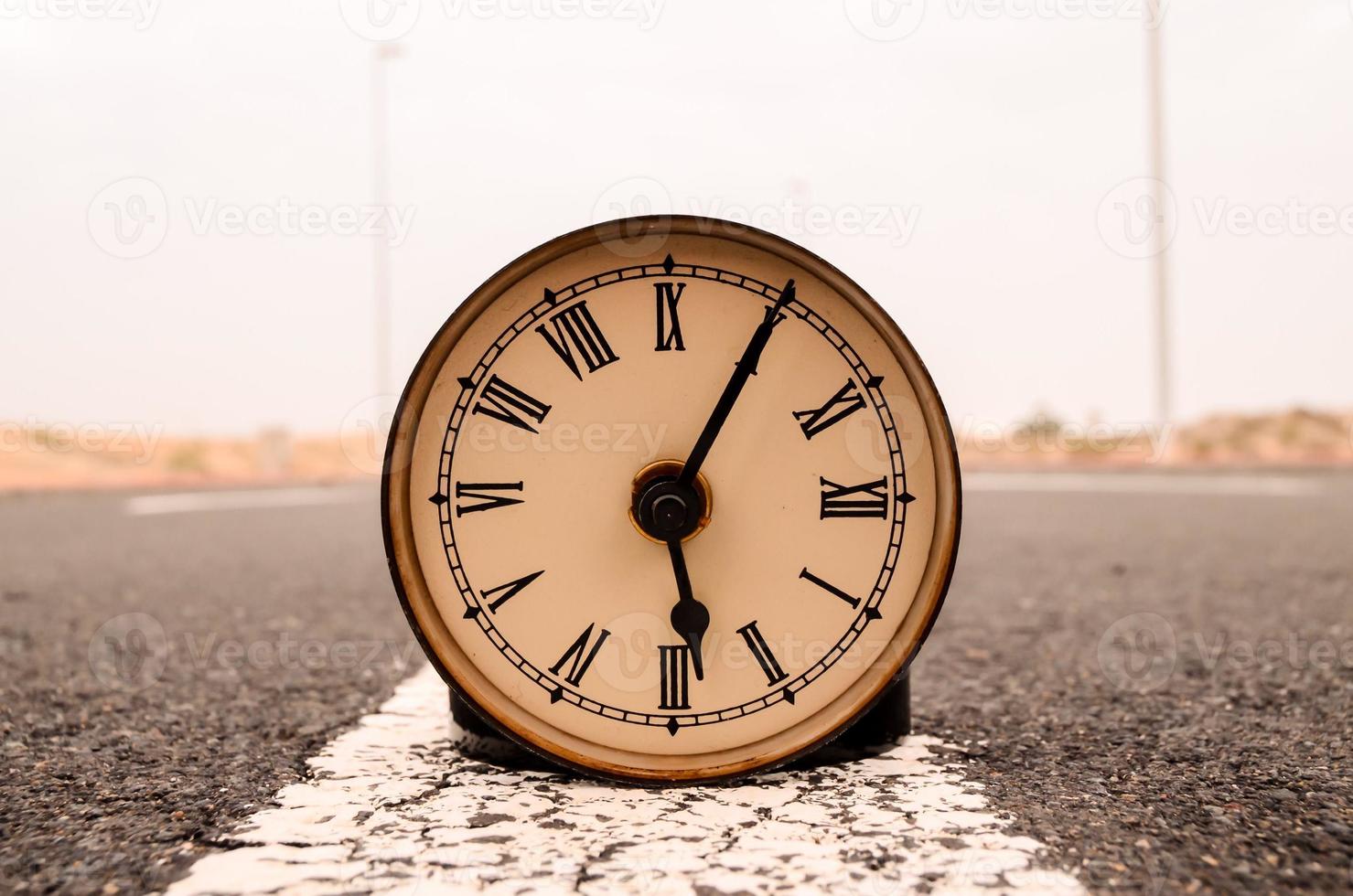 Clock on the road photo