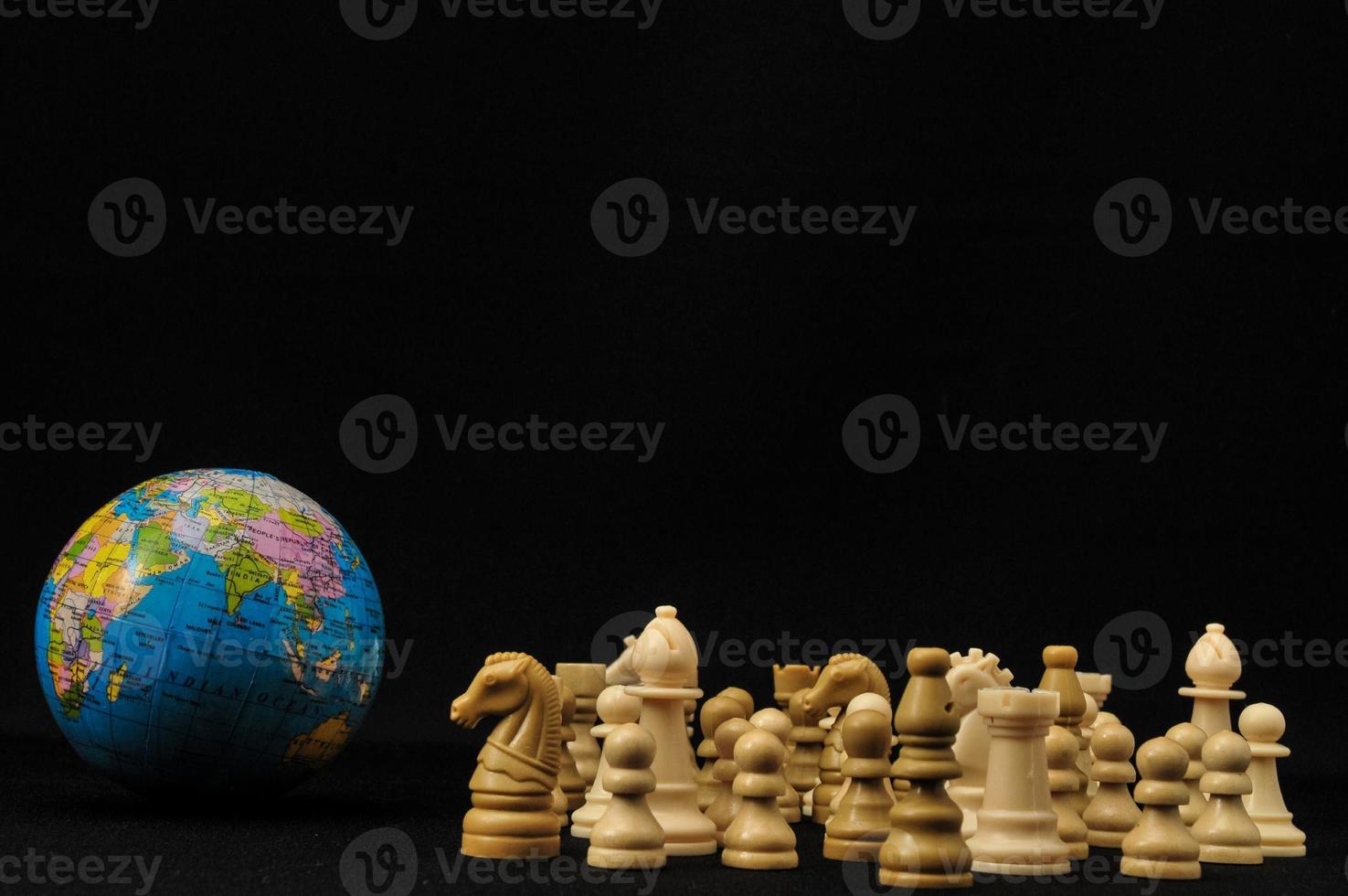 Globe and chess pieces photo