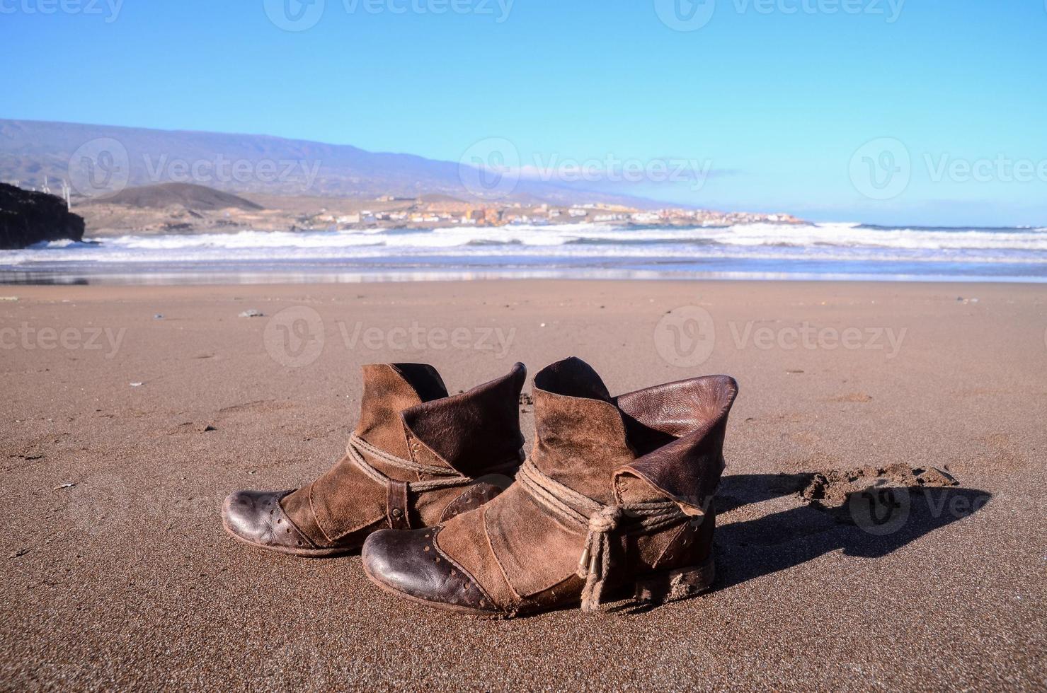 Boots on the beach 21591724 Stock Photo at Vecteezy