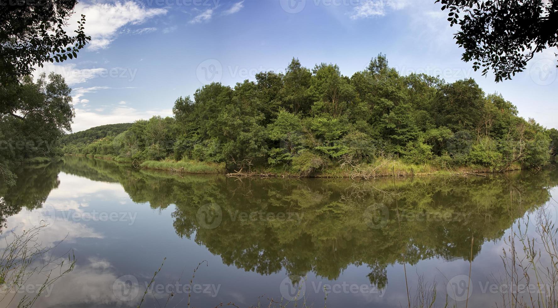 Panoramic view of a beautiful calm river with reflection. photo