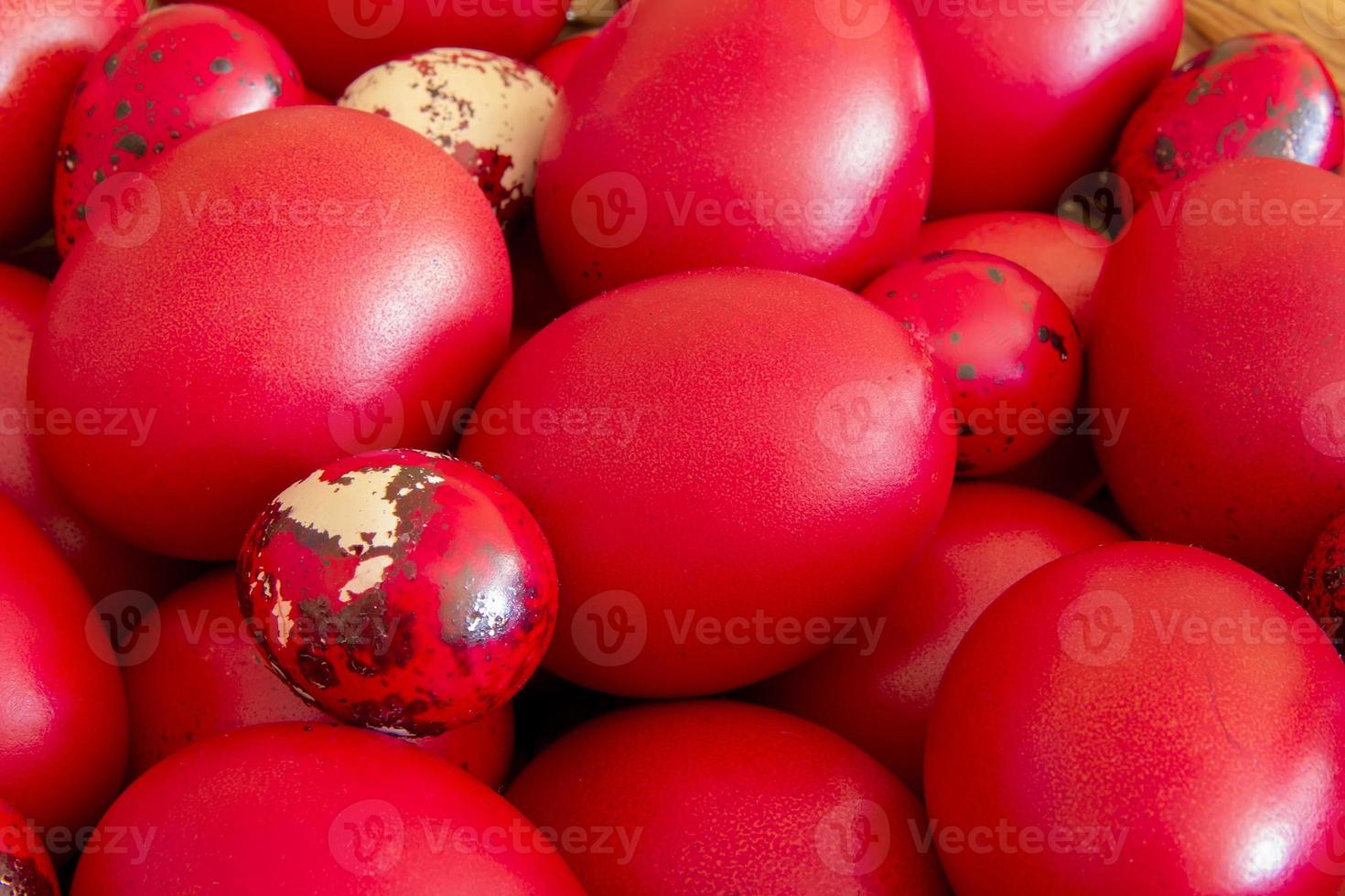 Many Easter red colored eggs in the basket on the table. Top view photo