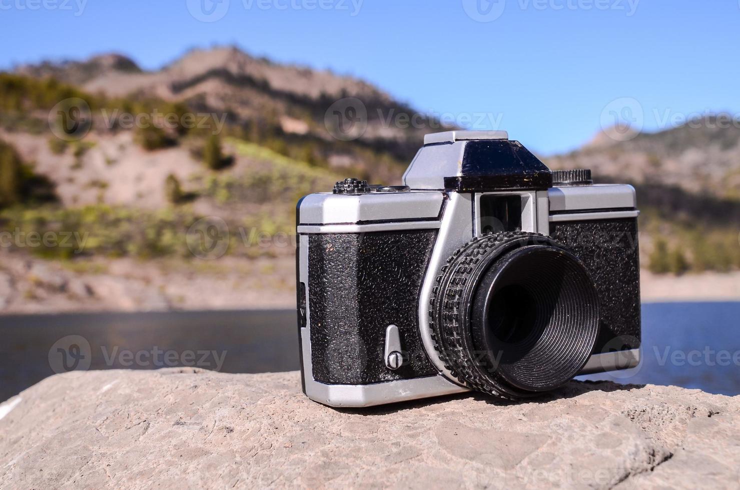 Old camera on a rock photo