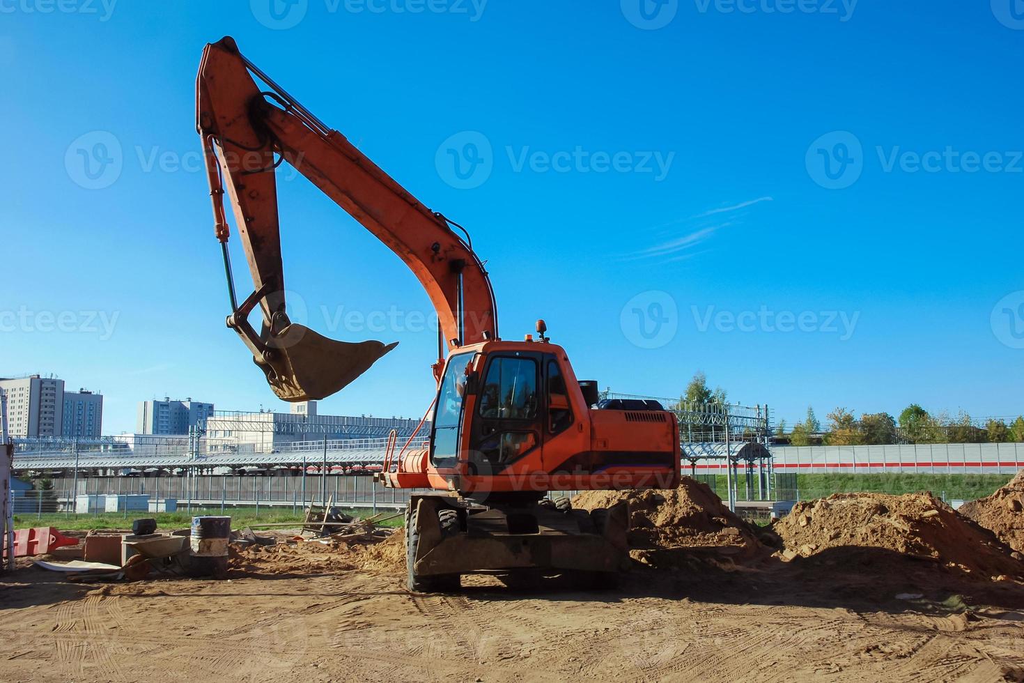 excavator at work against blue sky photo