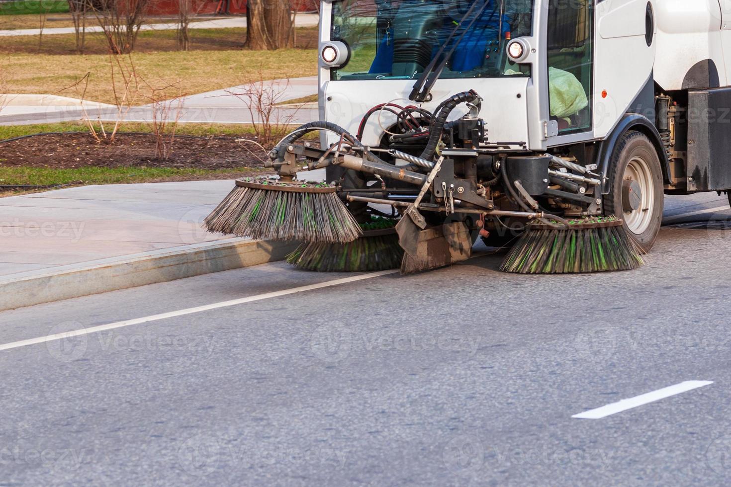 Road sweeper working on a spring day photo