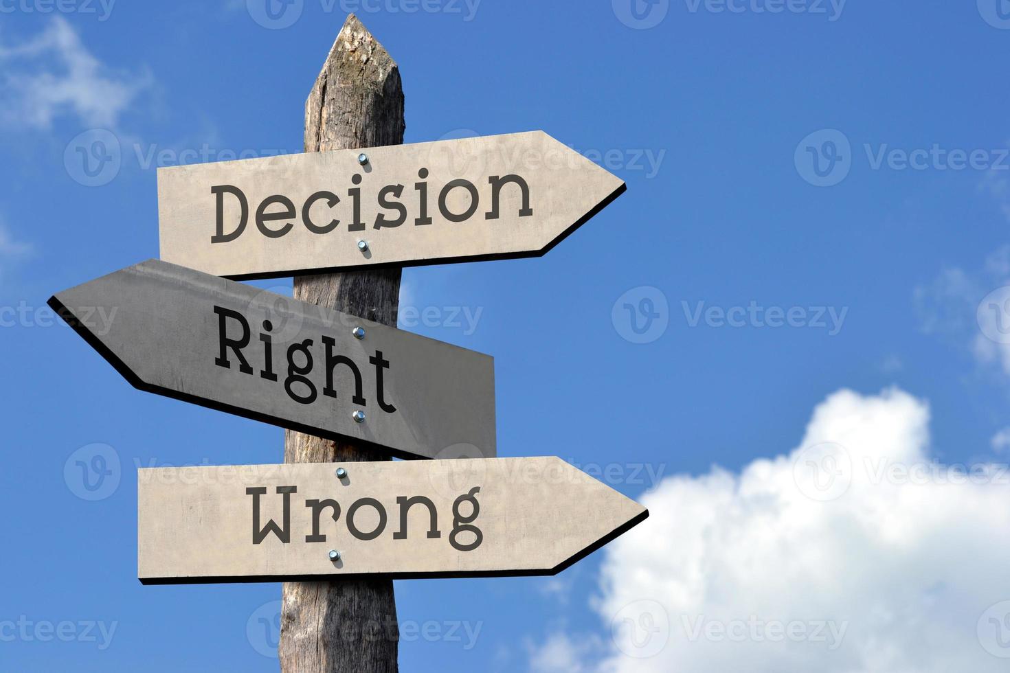 Decision, Right, Wrong - Wooden Signpost with Three Arrows, Sky with Clouds photo