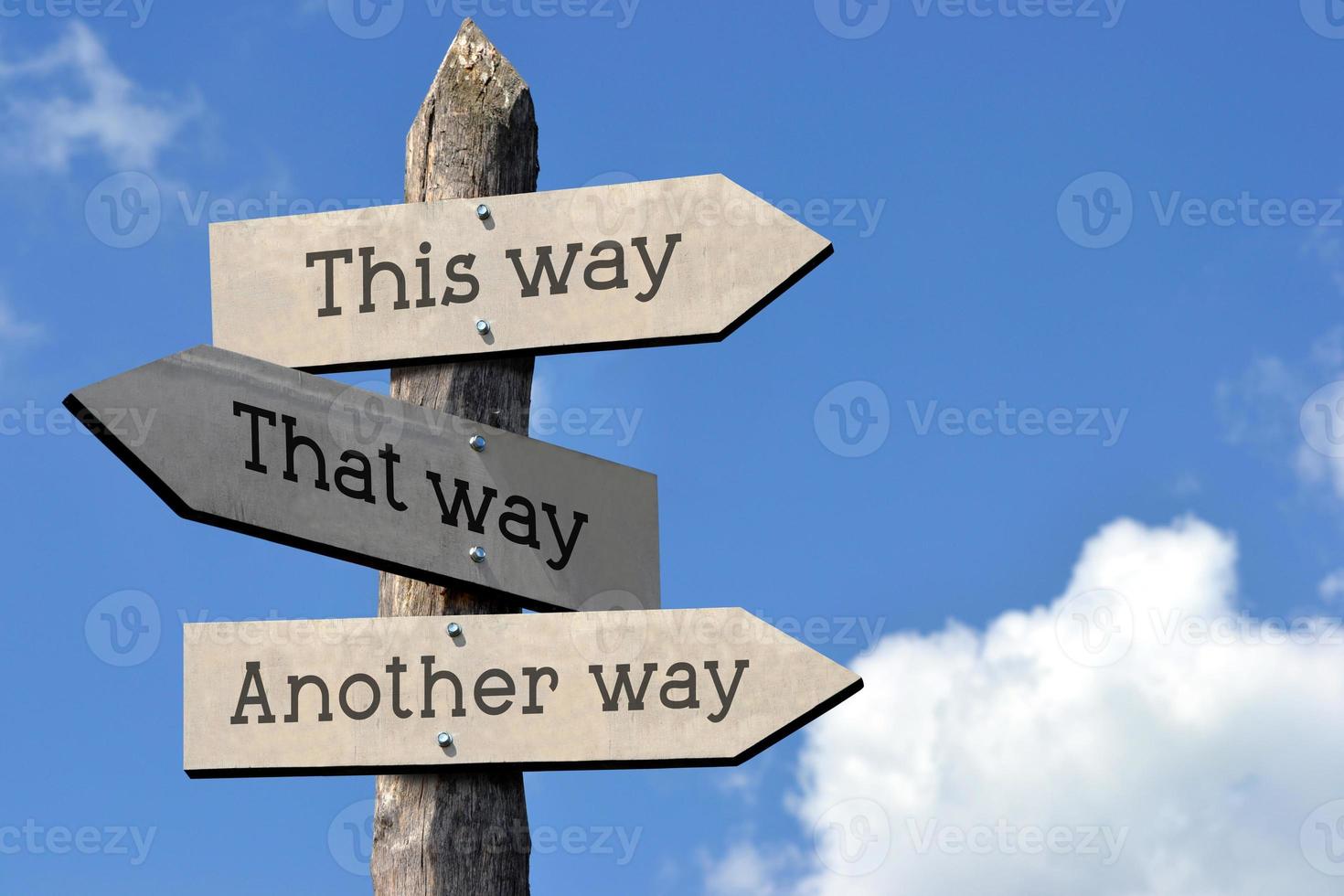 This Way, That Way, Another Way - Wooden Signpost with Three Arrows, Sky with Clouds photo